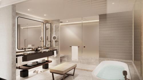 ein Badezimmer mit Badewanne und Waschbecken in der Unterkunft Anantara Siam Bangkok Hotel in Bangkok