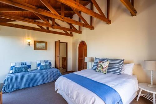 een slaapkamer met een groot bed en een bank bij 8 Tarbet Ness in Vosburg