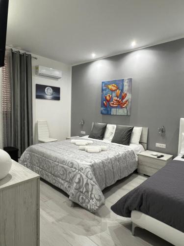 a bedroom with a large bed and a couch at Angela apartments in Partinico