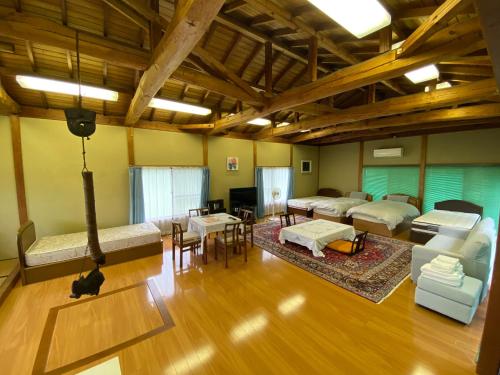 a room with two beds and a living room at Wakihonjin in Kikugawa