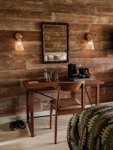 a wooden wall with a table and a mirror at The Royal George in Tintern