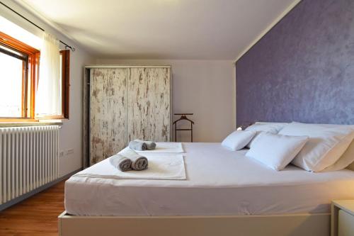a bedroom with a large white bed with towels on it at Villa San Rocco with heated pool in Vodnjan