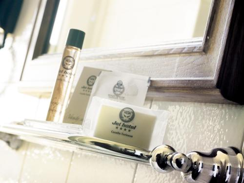 a window sill with two boxes and a toothbrush at Jet Hotel in Caselle Torinese
