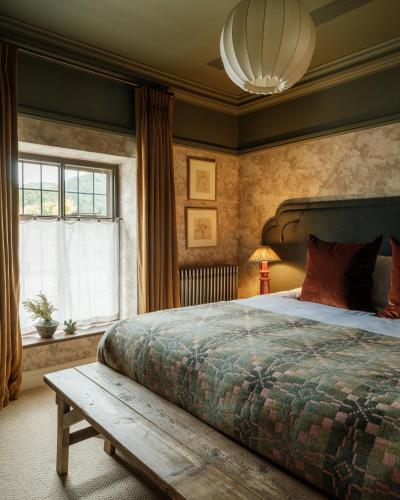 a bedroom with a large bed and a window at The Royal George in Tintern