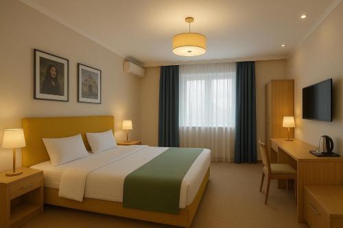 a hotel room with a bed and a desk at Rest Deluxe Hotel in Baku