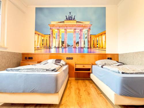 two beds in a room with a building in the background at 33 - 17 Hotelkamer voor twee personen in Marx in Bunkenburg