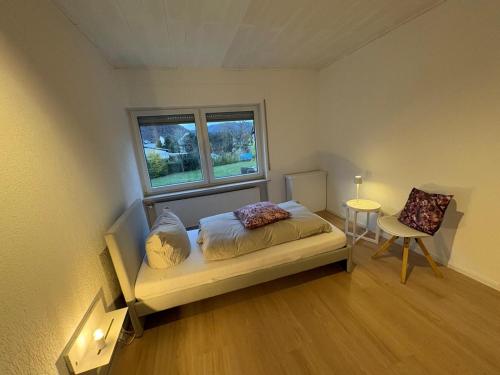a small bedroom with a bed and a window at Moselfreunde Ellenz-Poltersdorf in Ellenz-Poltersdorf