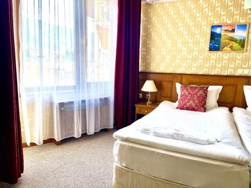 Ένα ή περισσότερα κρεβάτια σε δωμάτιο στο Хотел Елит Релакс