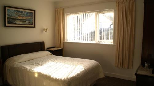 a bedroom with a bed and a window at Rockville in Cashel