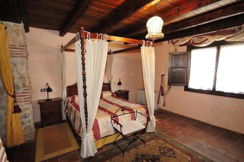 a bedroom with a canopy bed in a house at Estudio Ducal in Peñaranda de Duero