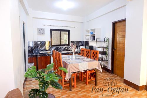 a kitchen and dining room with a table and chairs at Pan-Ogifan Transient in Baguio
