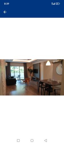 a living room with a table and a dining room at Lumut Valley in Lumut