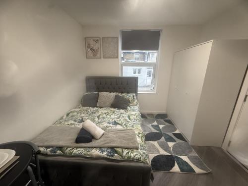 a bedroom with a bed in a room with a window at Modern Studio - Centre Maidstone in Maidstone