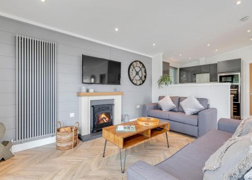 a living room with a couch and a fireplace at Celtic Escapes in Narberth