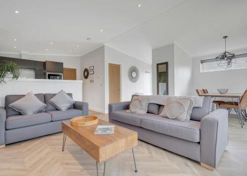 a living room with two couches and a coffee table at Celtic Escapes in Narberth