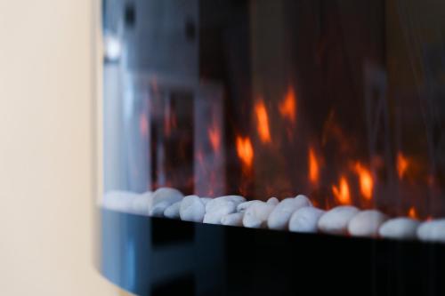 a row of white balls in front of a stove at White House Apartman Miskolc, East Room in Miskolc