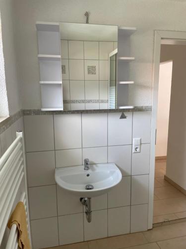 a bathroom with a sink and a mirror at Eigentumswohnung für 5 Personen in Donzdorf
