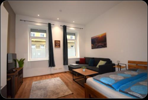 a living room with a bed and a couch at Cozy Apartments in Central Location with Free Parking on Availability in Vienna