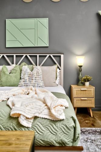 a bedroom with a bed with a blanket on it at The Magnolia - Farmhouse Loft - Sleeps 10 - Valet in Dallas