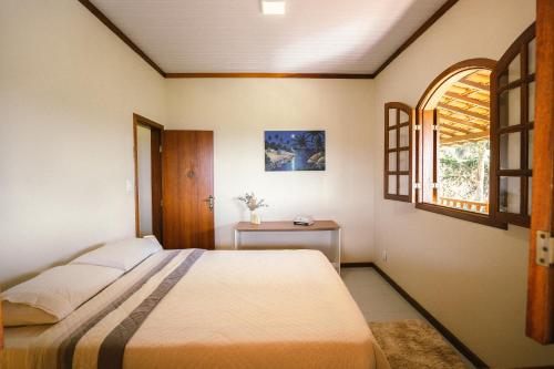 Ένα ή περισσότερα κρεβάτια σε δωμάτιο στο Carcará Vacation Homes