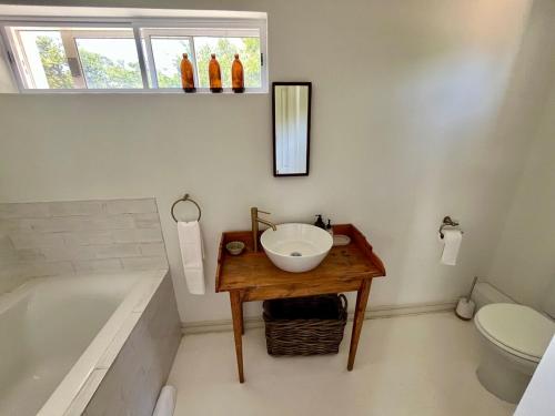 a bathroom with a sink and a bath tub at Jonkershuis Farm Retreat in Heidelberg