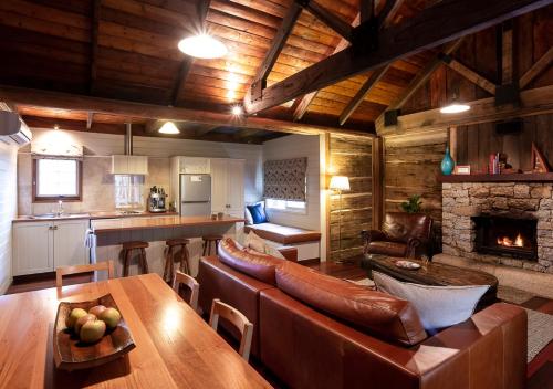 a living room with leather furniture and a fireplace at 1860 Luxury Accommodation in Beechworth
