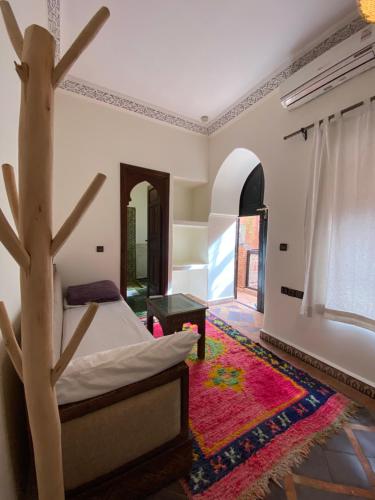 a bedroom with a bed and a tree in it at Riad Musa in Marrakech