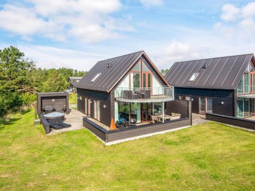 a home with a large yard with a house at Exclusive Golf View Retreat in Rømø Kirkeby