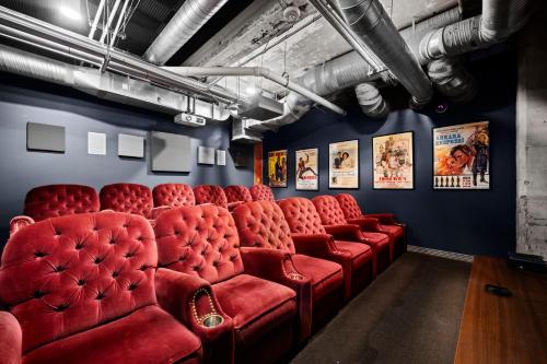 a room with red chairs and posters on the walls at The Magnolia - Farmhouse Loft - Sleeps 10 - Valet in Dallas