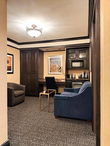 a living room with a blue couch and a chair at Hotel Lucerne in New York