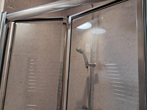 a shower with a glass door in a bathroom at Cosy 2 Bedroom Luxury House in Wednesbury