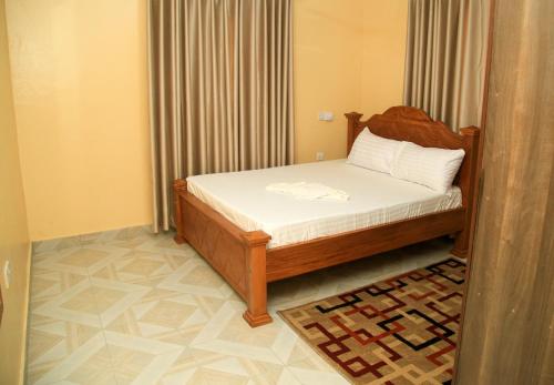 a small bedroom with a bed and a rug at The Hidden Paradise in Mombasa