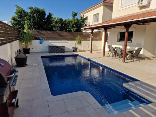 a swimming pool in the backyard of a house at Suburban Family Villa in Limassol