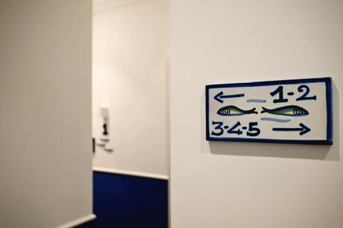a sign on a wall with fish on it at Omnia Luxury Suite in Salerno