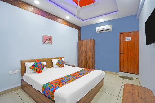 a bedroom with a bed and a television in it at FabHotel Super Corridor 