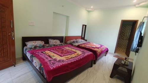 Voodi või voodid majutusasutuse Magic Mist Inn Yercaud toas