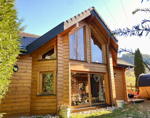 a log cabin with a large window at Villa Aurora in Orbey