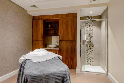 a bathroom with a shower and a bed in a room at Landal Kenwick Woods in Louth