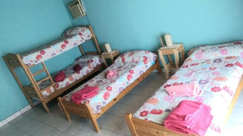 ein Zimmer mit drei Etagenbetten in einem Zimmer in der Unterkunft Tierra De Artes in Vuelta de Obligado