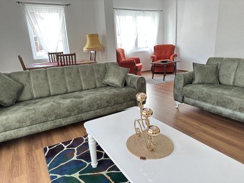 a living room with a couch and a table at A&A Apartments Prizren in Prizren