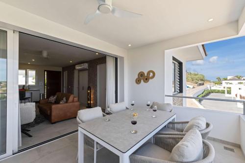 a living room with a table and chairs at Coral Whisper - Aquamarine 8 in Willemstad