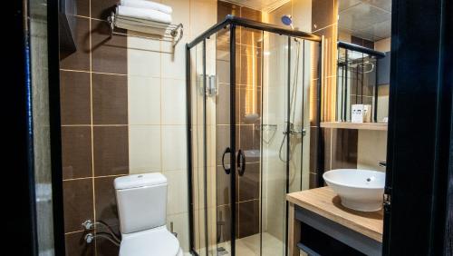 a bathroom with a shower and a toilet and a sink at Kaf Mount Erciyes in Hacılar
