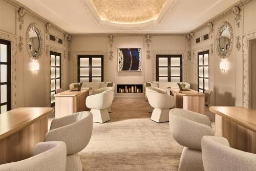 a waiting room with white chairs and tables at The Berkeley, Maybourne in London
