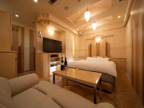 a hotel room with a bed and a couch at ホテルレジェンドプラス-Adult only in Kyoto