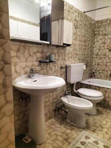 a bathroom with a sink and a toilet at Appartamento l'angelo in Predazzo