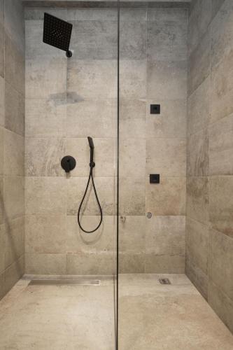 a shower with a glass door in a bathroom at Oasis Pool House in Ranilović