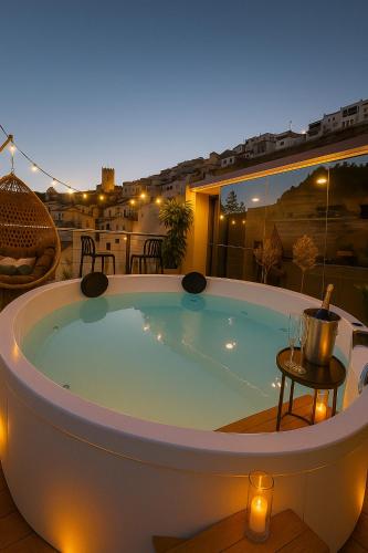 a large jacuzzi tub on a patio at night at La Suite Secreta del Júcar in Alcalá del Júcar