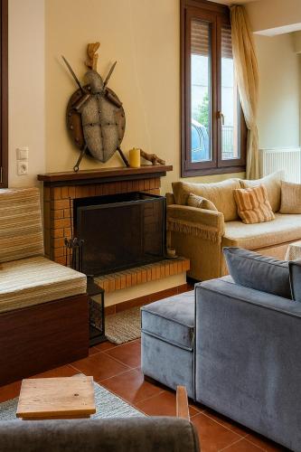 a living room with a couch and a fireplace at Wood & Chill in Elevtherokhórion