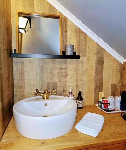 a bathroom with a sink and a mirror at Prestshús 2 Guesthouse in Vík