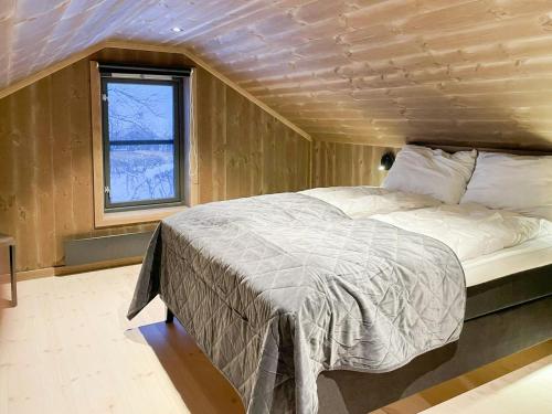 a bedroom with a bed in a room with a window at Mountain Cabin At Hardangervidda in Uvdal